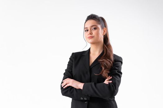 Young business woman arms crossed in black jacket standing studio isolated on white background.