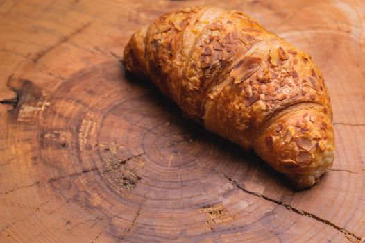 Freshly baked croissant on a wooden Tray. Delicious and healthy breakfast