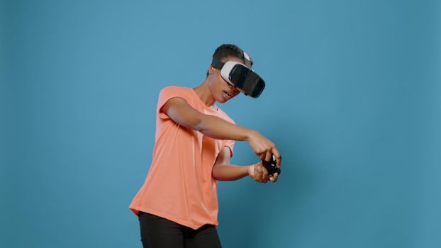 Modern woman using vr glasses and controller to play video games