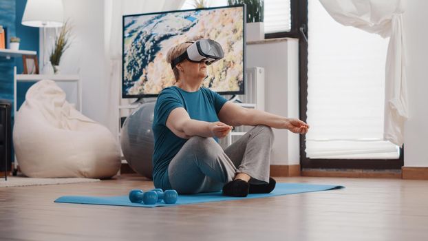 Retired woman meditating in lotus position with vr glasses