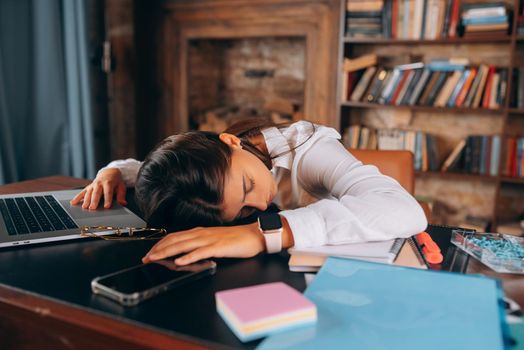Young beautiful woman fell asleep at her desk