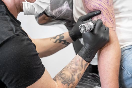 Salon tattoo. Close up of a Tattoo artist working. Tattoo artist make tattoo at the studio.