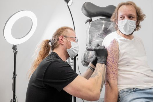 Tattoo artist making tattoo at the studio