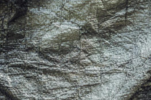 Abstract real fabric surface background. Aluminum Platinum Silver foil Tarpaulin effect with rough texture burlap edge. Futurism 80s retro style new year. Dark Grey black tone design. More in stock