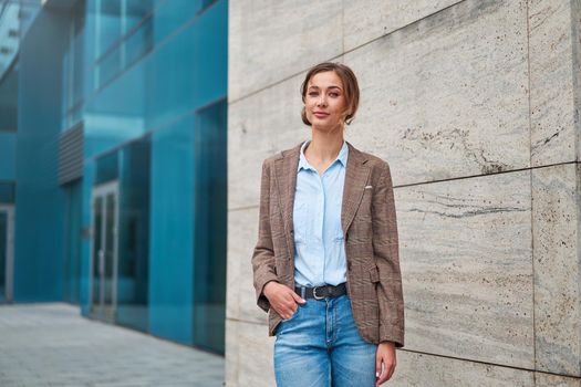 Businesswoman successful woman business person standing outdoor corporate building exterior. Pensiv caucasian confidence professional business woman middle age