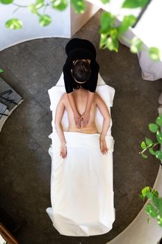 Top view of woman receiving a massage in calm and serene space.