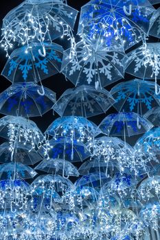 White umbrellas iluminated by Christmas lights