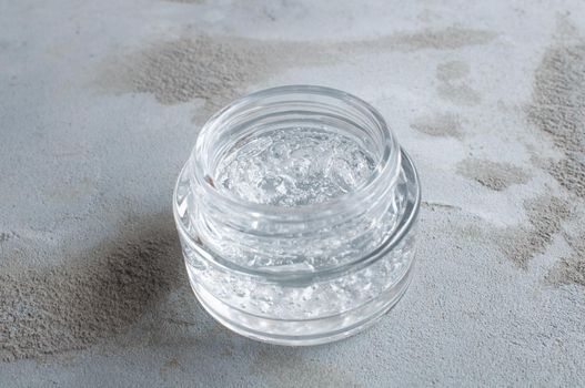 Gel with hyaluronic acid and aloe vera branches in a glass jar