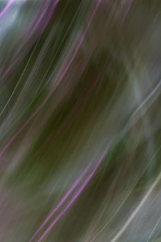 Abstract purple green hazy background. Light blur. Oblique lines and waves. Backdrop.