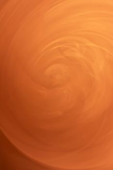 Orange sand swirl. Vertical abstract. Backdrop