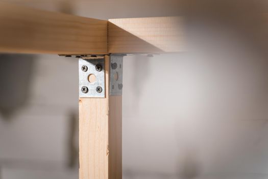 Corner connection of wooden bars with iron corners and black self-tapping screws