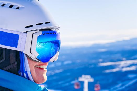 Portrait of woman in alps. woman in ski goggles at the ski resort. reflection in ski goggles