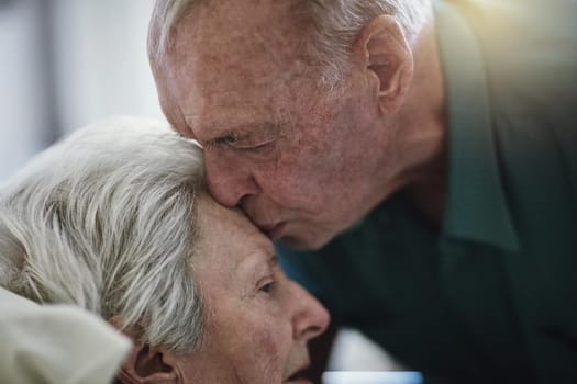 Love is eternal. Shot of a senior man visiting his wife in hospital.
