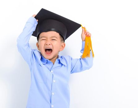 Happy Kid boy in graduation cap and having fun