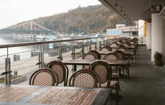 Kyiv, Ukraine, November, 2020. Evening in a empty restaurant with terrace along the Dnipro river coast. Closed on quarantine restaurant. Take away or delivery. High quality photo.