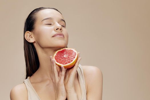 portrait woman grapefruit in hands posing clean skin isolated background