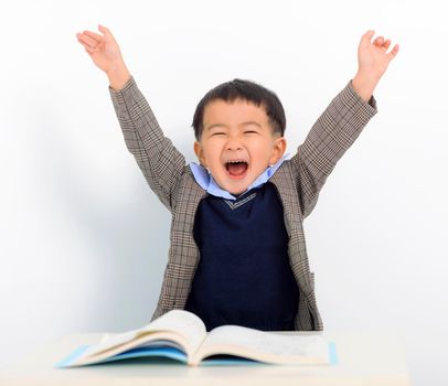 Excited little boy is reading book