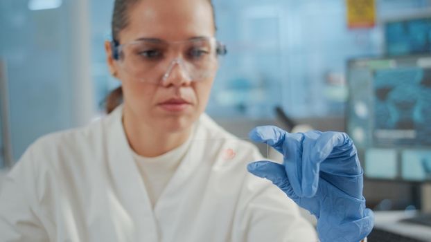 Close up of biologist analyzing blood sample on lab glassware