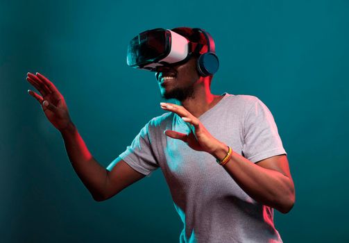 Smiling model playing virtual game on interactive vr goggles