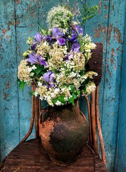 Romantic bouquet with viburnum inflorescences, irises, alliums and horseradish inflorescences