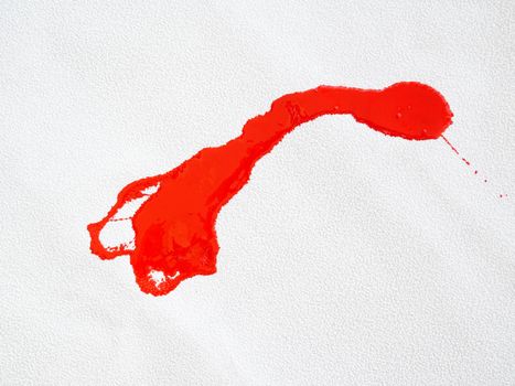 red blot and splatter paint on white background