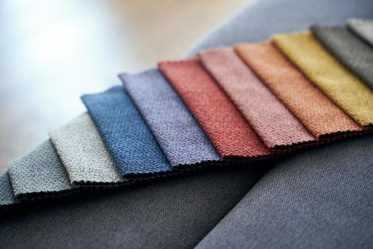 Colorful upholstery fabric samples on the home sofa