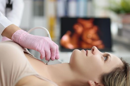 Doctor's hands on woman's neck, ultrasound thyroid gland