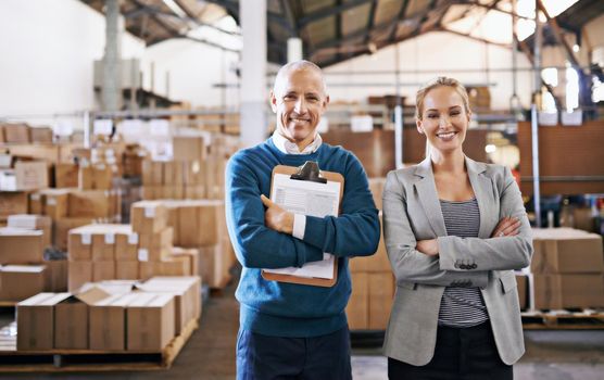 Your shipment is in capable hands. Portrait of two managers standing in a distribution warehouse.