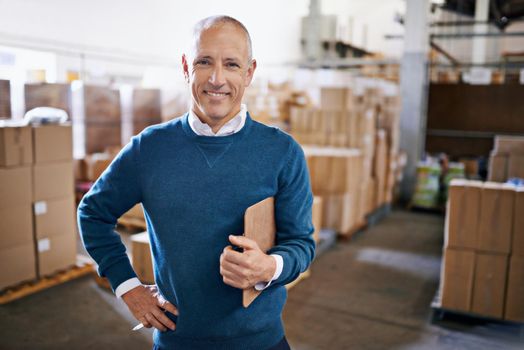 Tracking your shipment from start to finish. Portrait of a mature man standing in a distribution warehouse.