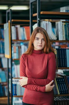 A girl holding a book shelf, student in the library