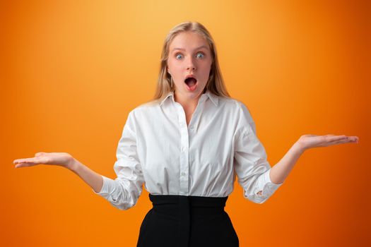 Shocked joyful teen girl against orange background