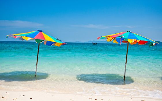 Beach chair under the umbrella of colorful on the beach Phuket, Thailand