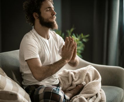 A Strong Man in Pajamas Has his Meditation. Usual Meditation at the Beginning of the Day. Close-up
