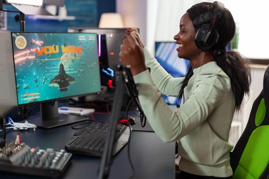 Happy african american woman gamer wearing headset