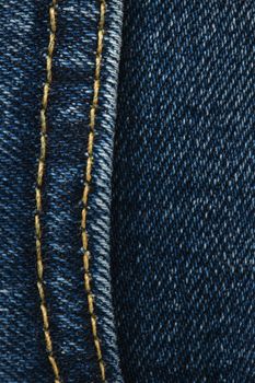 Seams on jeans close-up. Stitching on denim. Close up of blue jeans background. Denim texture