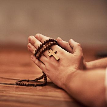 Hes always there to answer your prayers. Cropped shot of a man holding a rosary and praying.