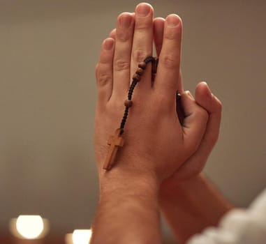 Faith will find the answer. Cropped shot of a man holding a rosary and praying.