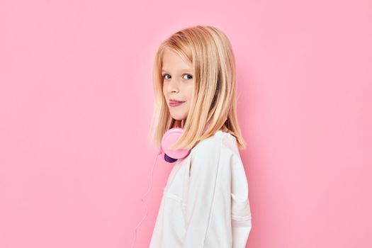 cute girl blonde hair headphones posing pink background