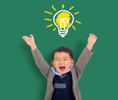 Happy Child student thinking and light bulb on the chalkboard . Cute little boy has an new idea. Innovation technology and education concept