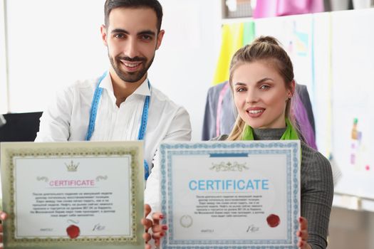 Man and woman team hold certificate, confirmation of high quality and service