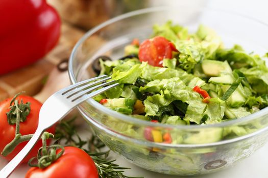 Delicious fresh greek salad with fresh lettuce leaves, tomato, cucumber, feta, olives, pepper