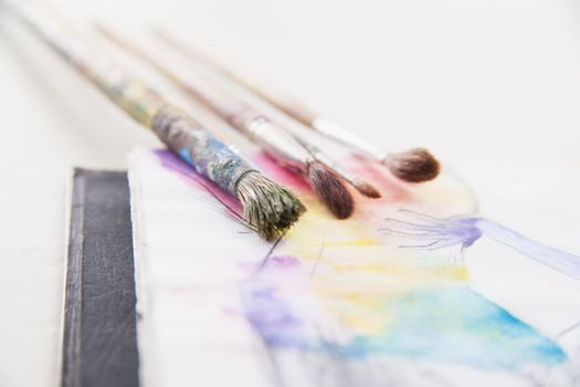 paint brushes lying on painted background