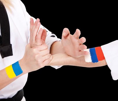 Power takeover Ukraine and Russia two fighting hands of representatives of different countries. Hold hands of two fighting people isolated on black background