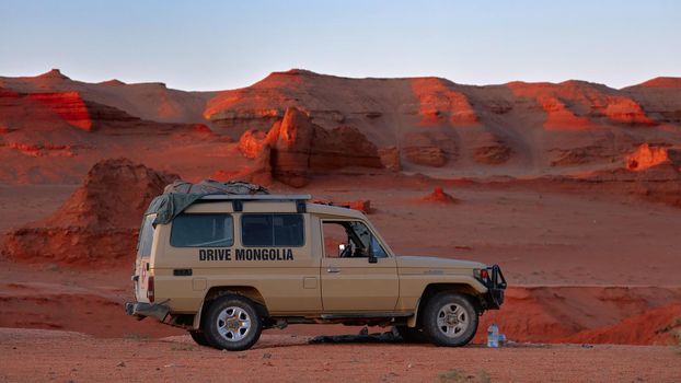 Toyota Land Cruiser in paleontological expedition to Herman Tsav Canyon. Martian landscape and The site of many paleontological finds. Cemetery of dinosaurs. 09.09.2019. Gobi Desert, Mongolia.