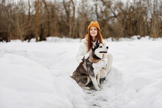 young woman with husky outdoor games snow fun travel Lifestyle. High quality photo