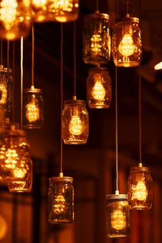 Light bulbs in glass jars. Cozy, warm atmosphere. Light Creative Decor