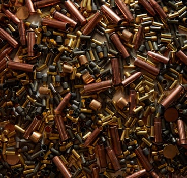 Different size bullet shells on the black ground. War concept. production of ammunition at the factory. brass bullet shell, ammunition manufacturing process
