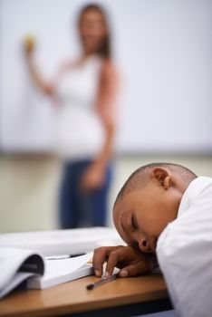 Falling asleep in class. A young boy sleeping in class.
