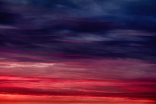 Colorful sunset with clouds in the evening. Abstract nature background. Dramatic and moody pink, purple and blue cloudy sunset sky