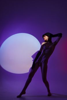 Beautiful fashionable girl posing on stage spotlight silhouette disco studio model unaltered
